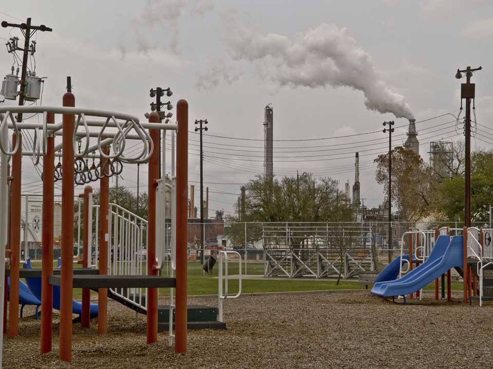 Playground with emissions stack in background