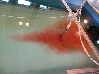 Dye added to flume allows study of channelized flow by turbidity currents under various water discharge conditions.